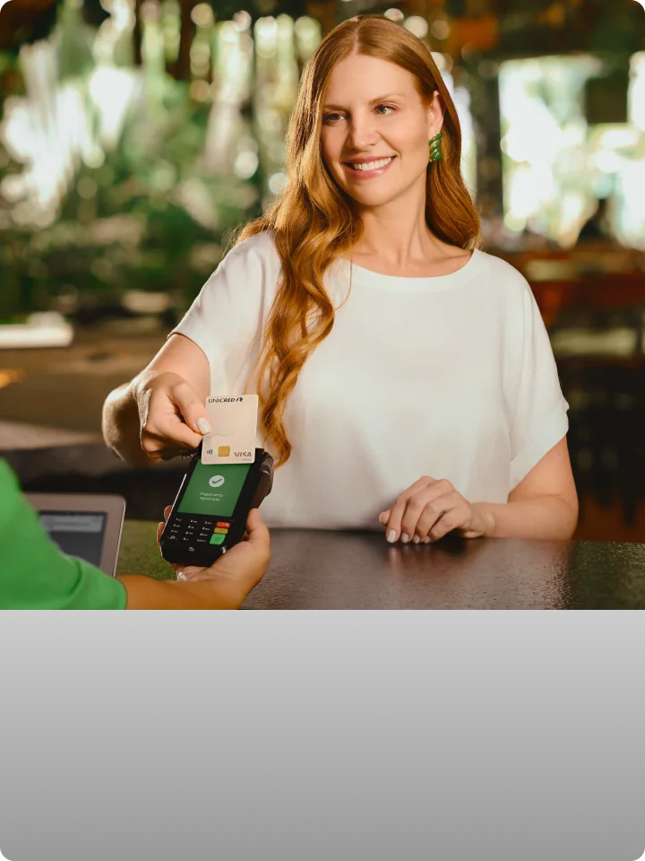 Mulher realizando pagamento com cartão Visa.